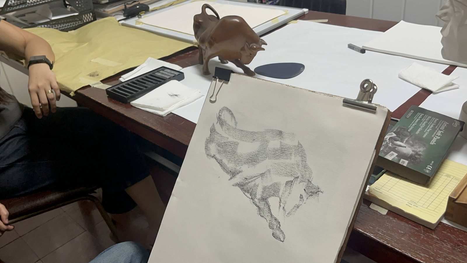 Bull study in progress on the board, with pastels and the reference sculpture
